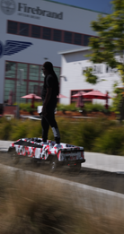 Cybertruck Large Scraperboard being ridden on a sidewalk