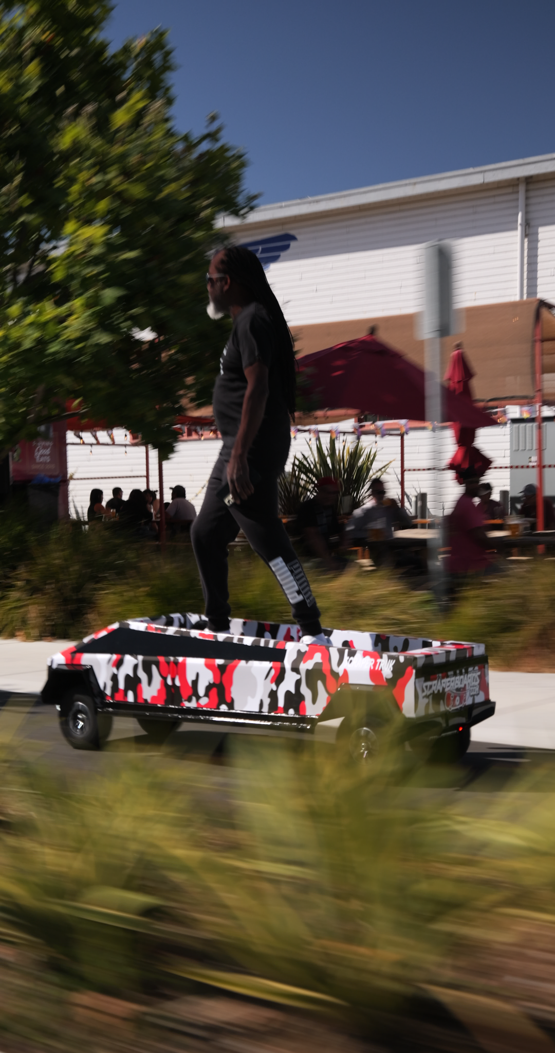 Cybertruck Large Scraperboard being ridden on a sidewalk